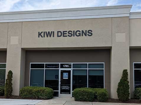 Showroom exterior with a sign "Kiwi Designs" 